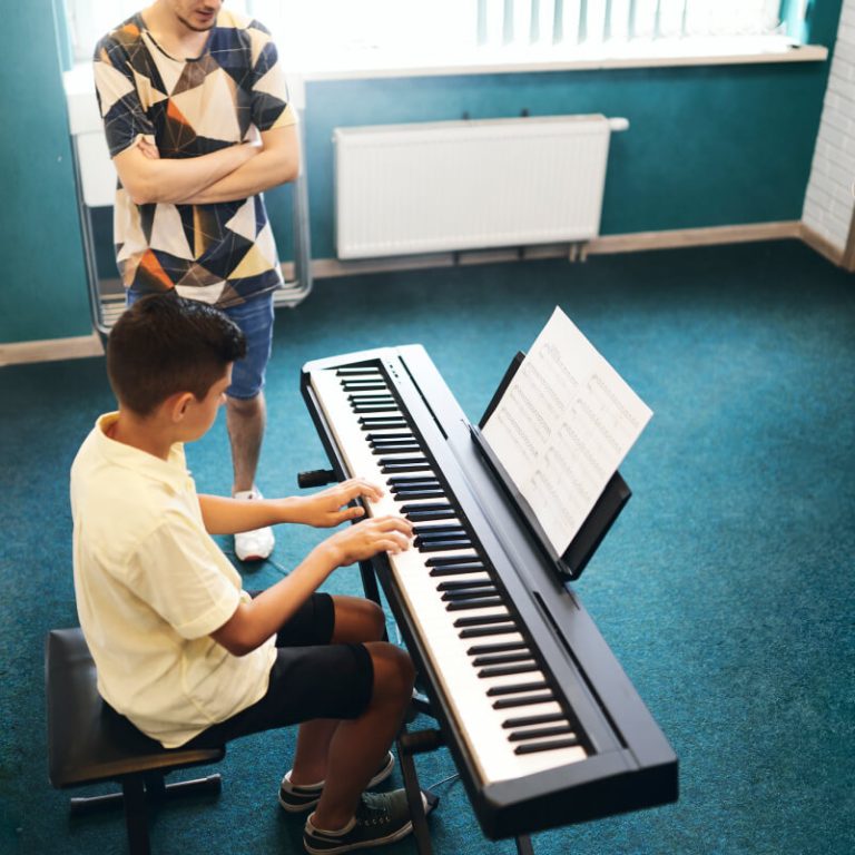 teacher-and-student-in-the-classroom-of-music-scho-2021-09-24-04-29-04-utc.jpg
